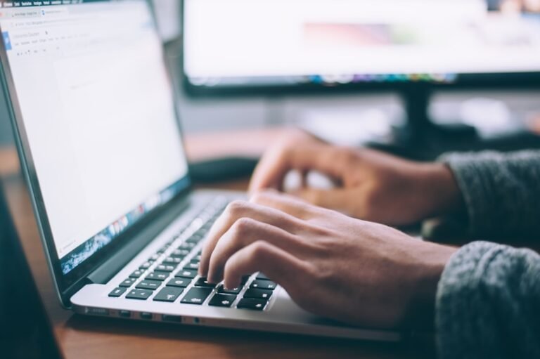 Writer working on a laptop, representing editorial links and SEO content outreach