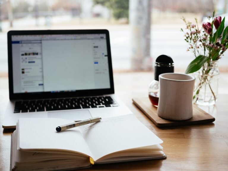 Laptop and notepad representing a guest posting service quality checklist