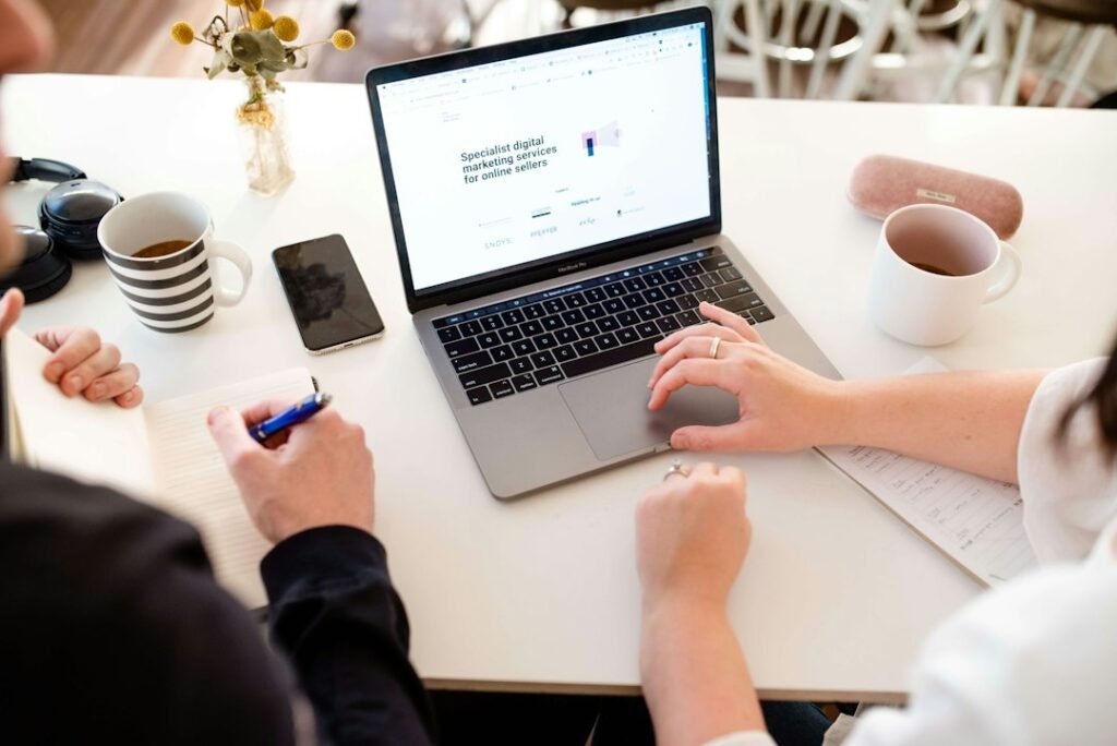 Two people collaborating on a marketing strategy at a desk